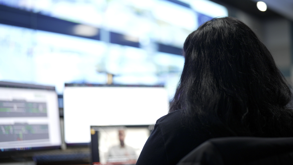 A Customer Communications Officer work area with monitors and a headset, set up for responding to customer questions.