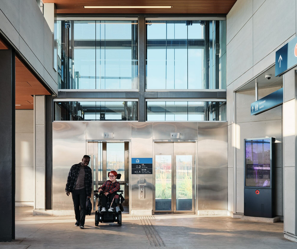 An image of a women on a wheelchair chatting with a friend