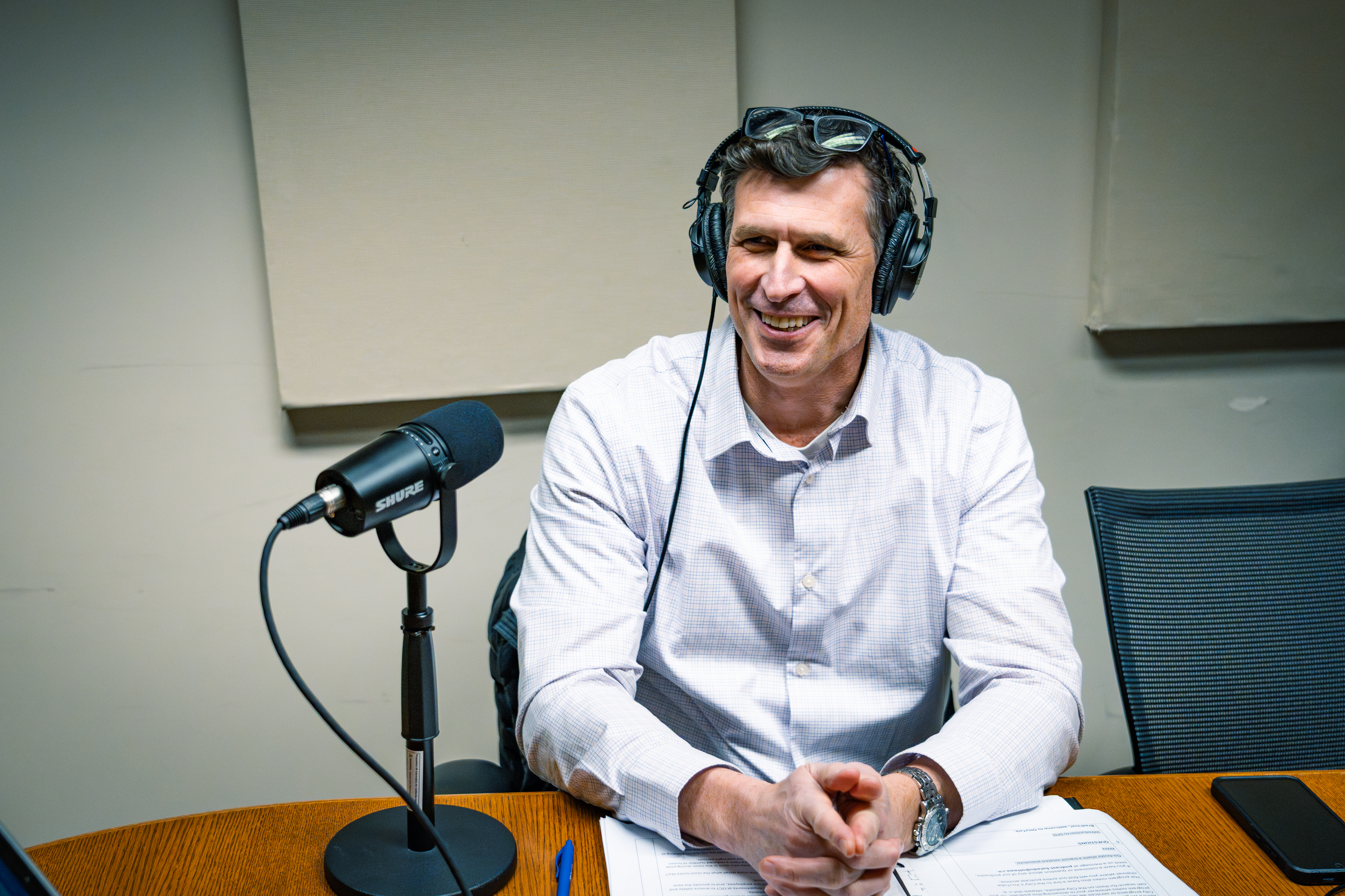 Brad Tubman, Manager of the Transit Operations Control Centre, seated at a microphone during an OttaTalk recording.